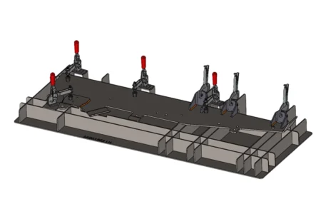 Custom welding fixture with toggle clamps for precise sheet metal positioning during fabrication.