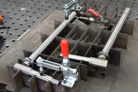 Custom precision welding fixture with toggle clamps and metal tubing secured for fabrication or alignment.