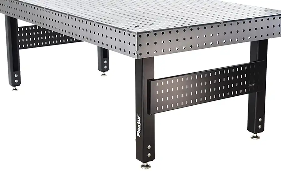 A metal welding table with a perforated steel surface and sturdy black legs, designed for industrial and workshop use.