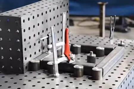 Pin and clamp table and modular fixtures holding workpiece